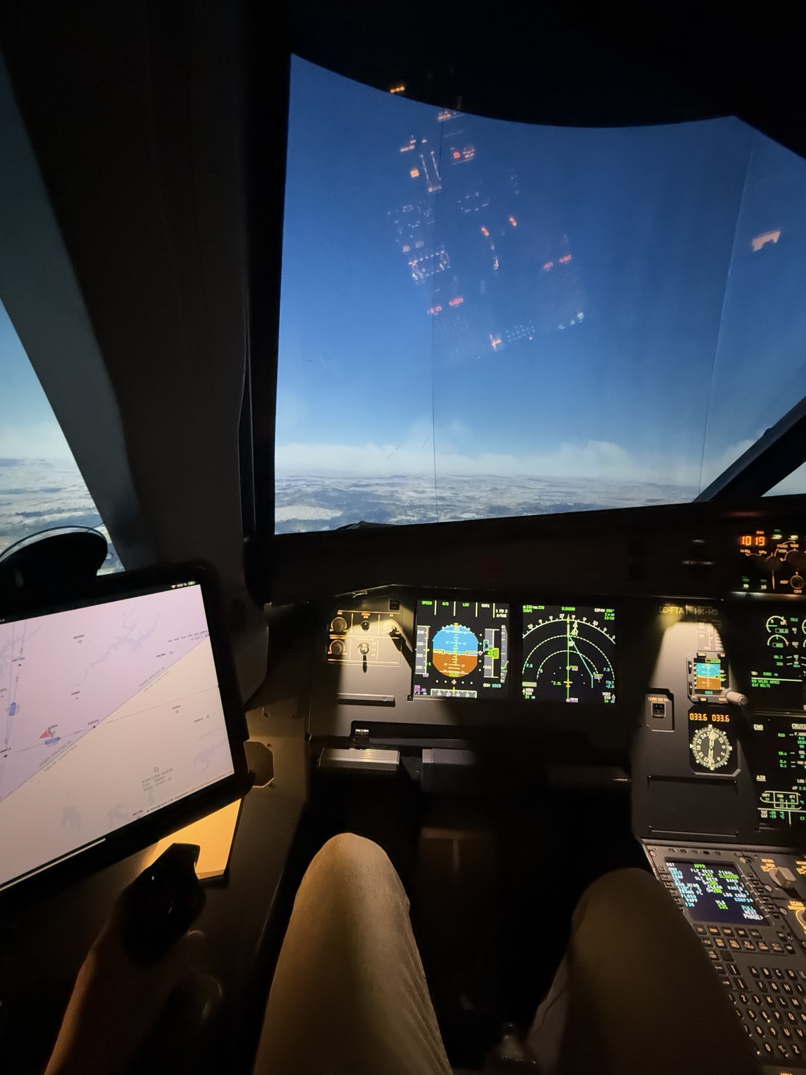 Stefan’s own photograph from the pilot seat of a flight simulator, showing the flight controls and view ahead